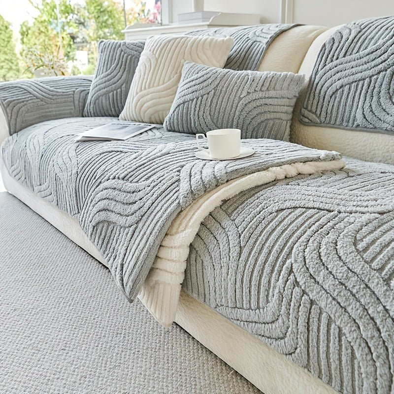 Gray textured sofa cover on a beige sofa with cushions and a cup.