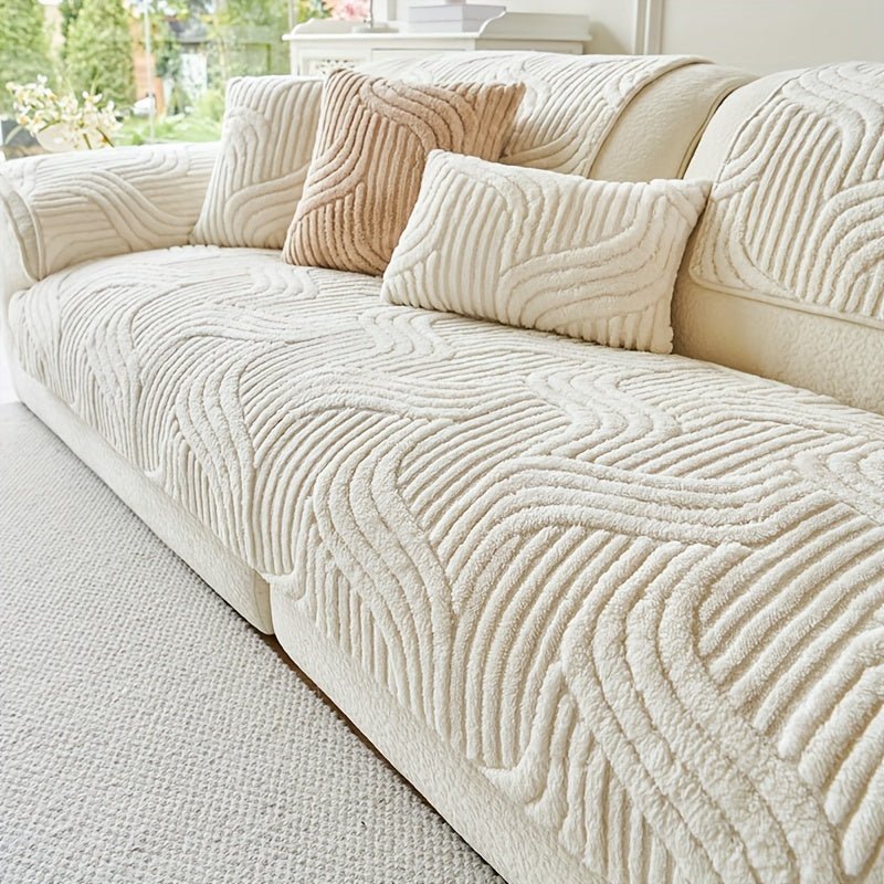 Beige textured sofa with decorative pillows in a living room setting