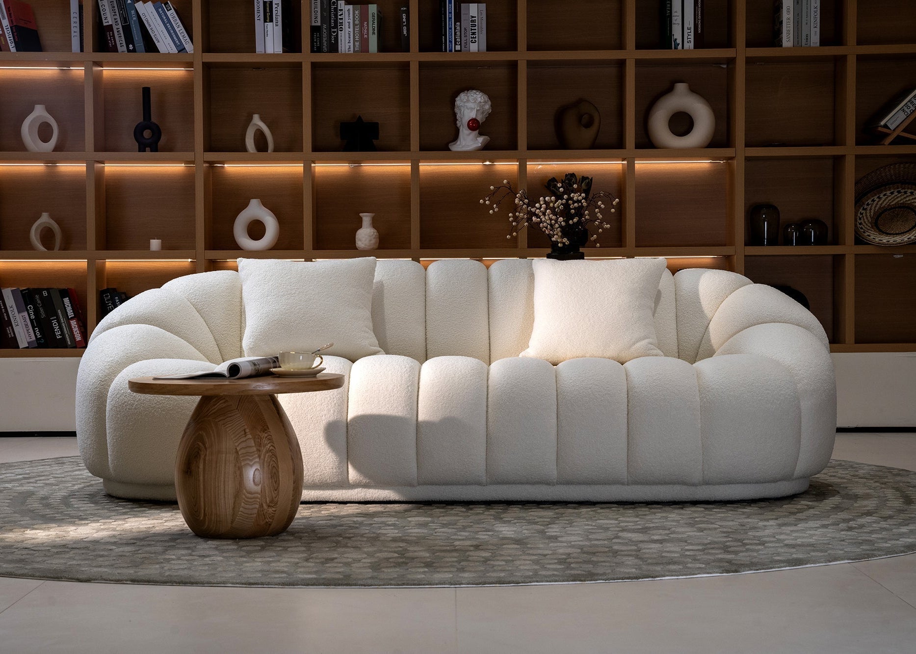 White sofa in a room with wooden shelves and décor